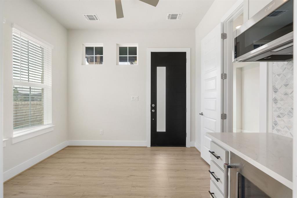 504 Tomichi Trail Austin, TX 78738 - Photo 7 of 36 a view of a hallway with wooden floor and windows