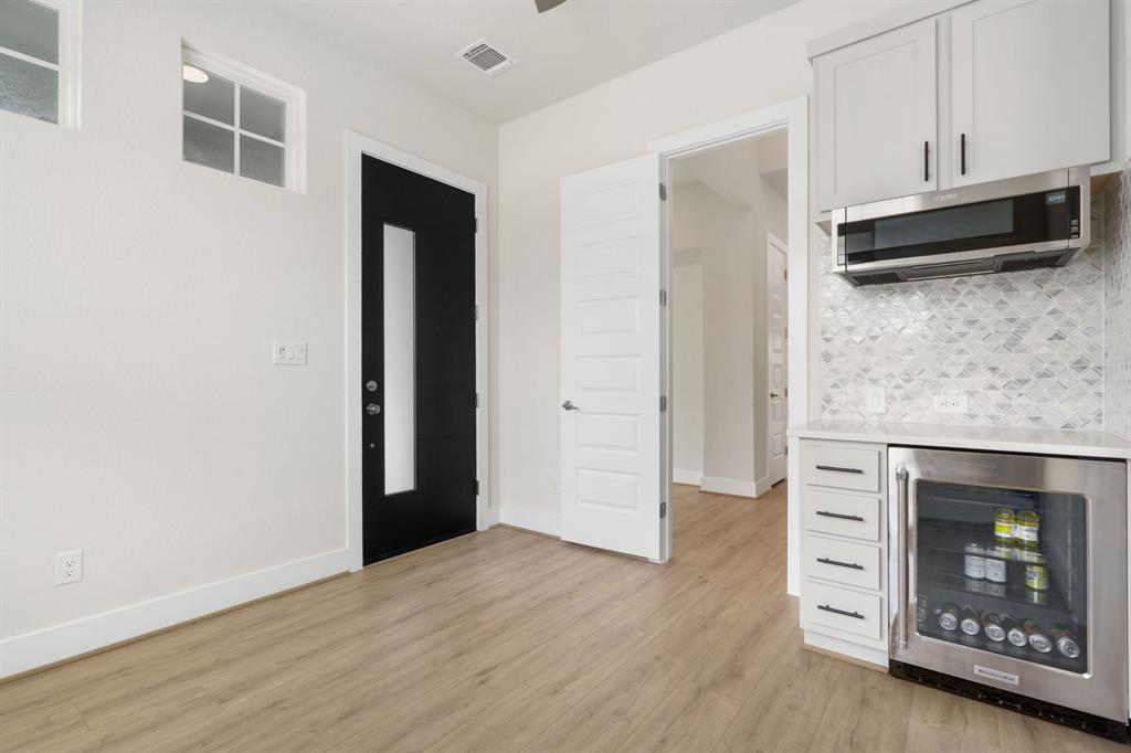 504 Tomichi Trail Austin, TX 78738 - Photo 9 of 36 a view of a kitchen with wooden floor and a fireplace