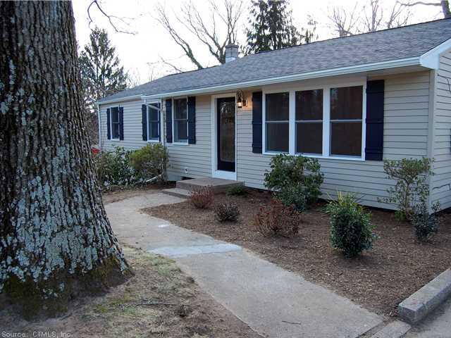 517 Mulberry Point Road Guilford, CT 06437 - Photo 1 of 1 a front view of a house with garden and porch