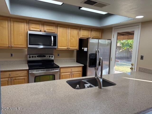 1105 West Juanita Avenue Mesa, AZ 85210 - Photo 12 of 25 a kitchen with stainless steel appliances granite countertop a refrigerator a stove and a sink with large window