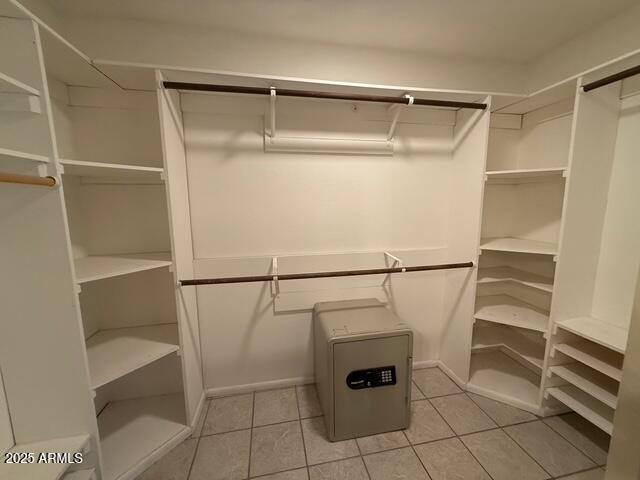 1105 West Juanita Avenue Mesa, AZ 85210 - Photo 15 of 25 a view of walk in closet with racks on the wall