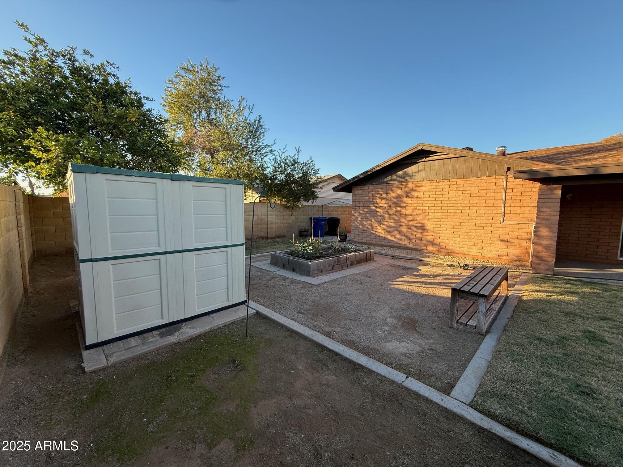 1105 West Juanita Avenue Mesa, AZ 85210 - Photo 23 of 25 a backyard of a house with barbeque oven