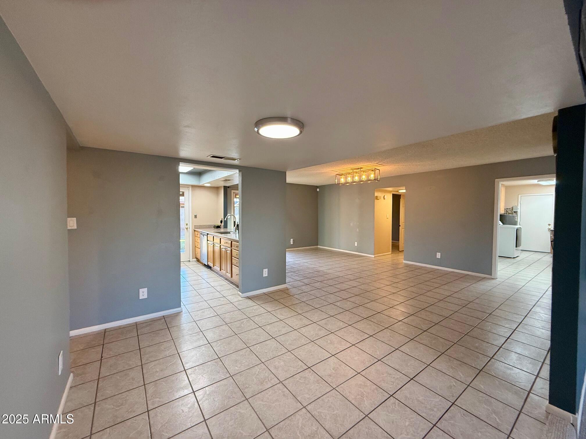 1105 West Juanita Avenue Mesa, AZ 85210 - Photo 5 of 25 a view of a hallway with wooden floor and a bathroom