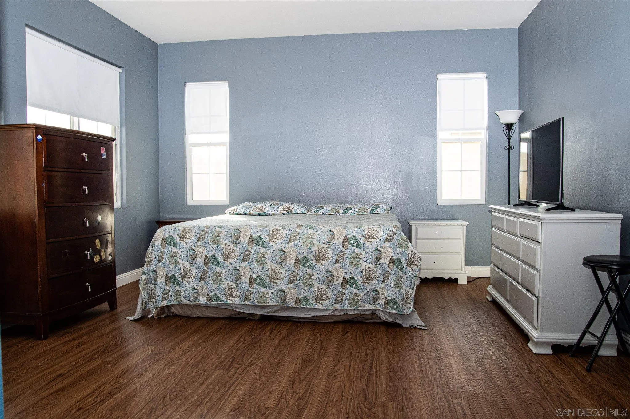 2131 Canvas Way San Jacinto, CA 92582 - Photo 17 of 36 a bedroom with a bed and a flat tv screen on the dresser