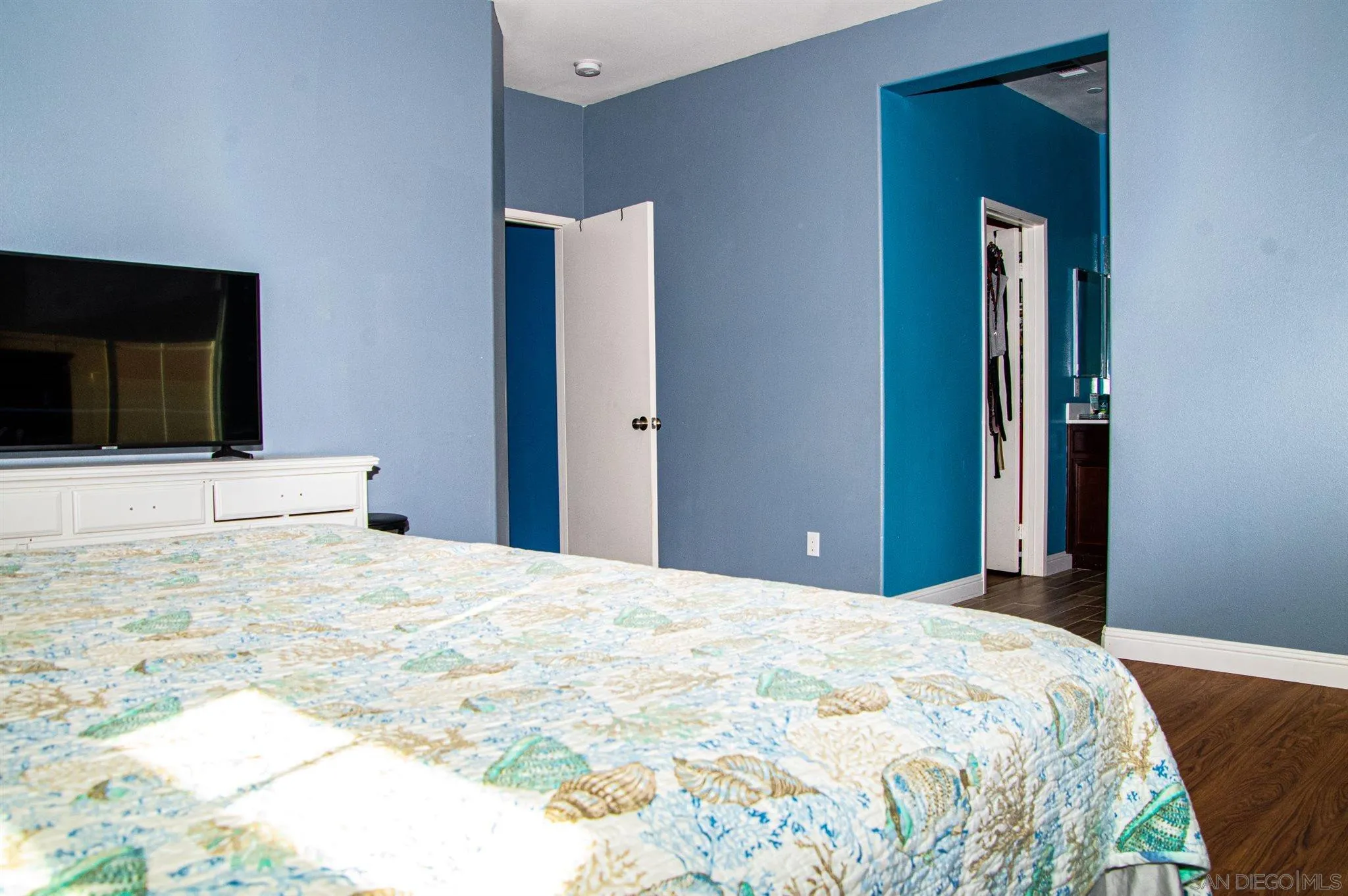 2131 Canvas Way San Jacinto, CA 92582 - Photo 18 of 36 a bedroom with a bed and a flat tv screen on dresser