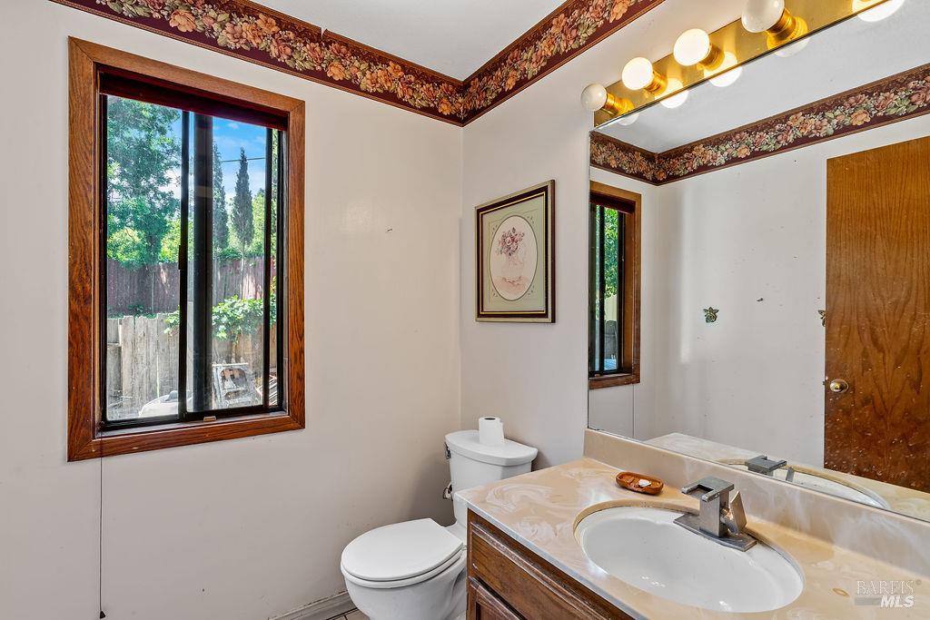 715 Placer Court Santa Rosa, CA 95401 - Photo 15 of 37 a bathroom with a sink mirror and toilet