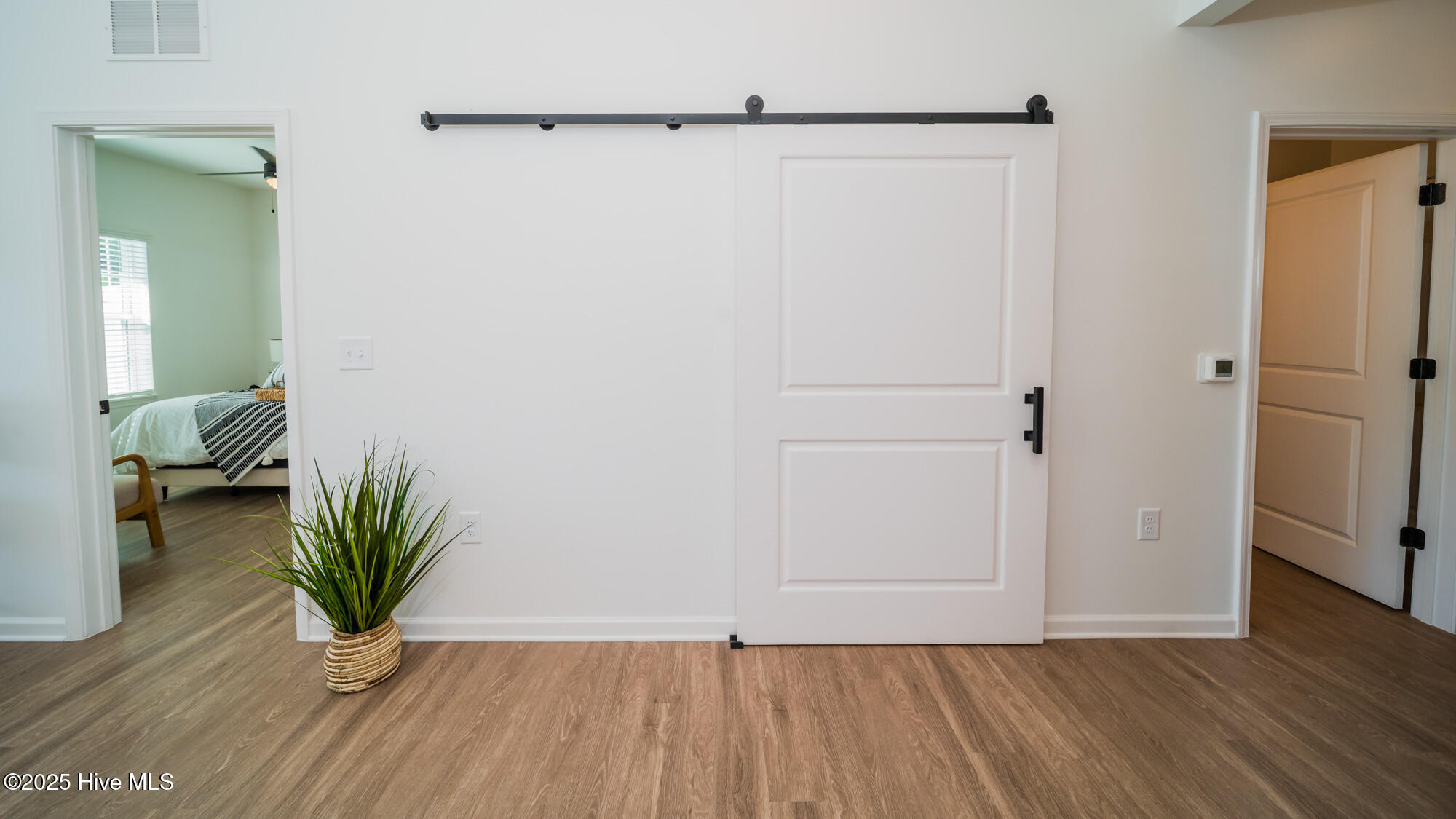 128 C Marcella Lane, Unit 102 Calabash, NC 28467 - Photo 13 of 34 barn door hides washer/dryer