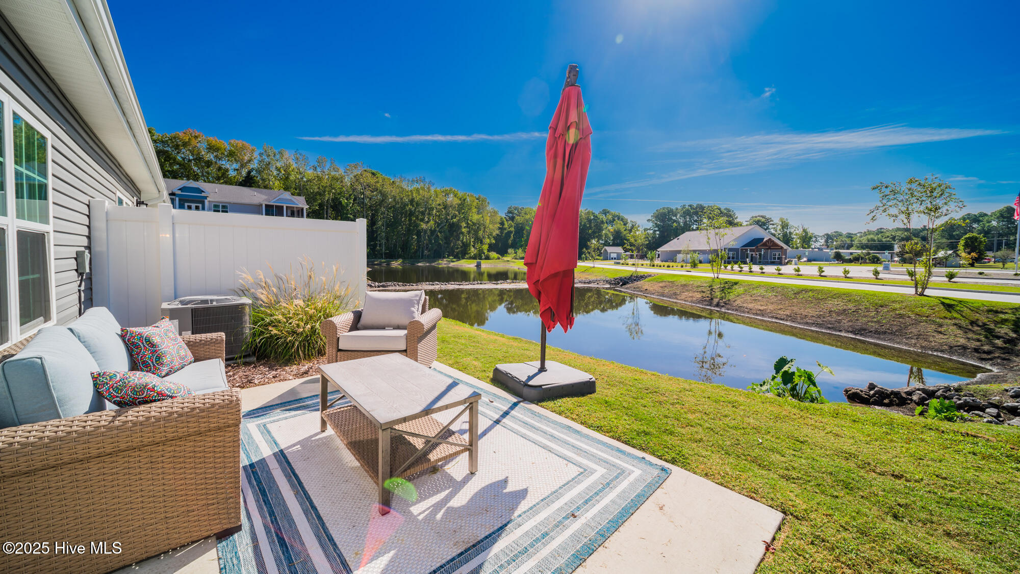 128 C Marcella Lane, Unit 102 Calabash, NC 28467 - Photo 21 of 34 Sunny patio to enjoy the pond