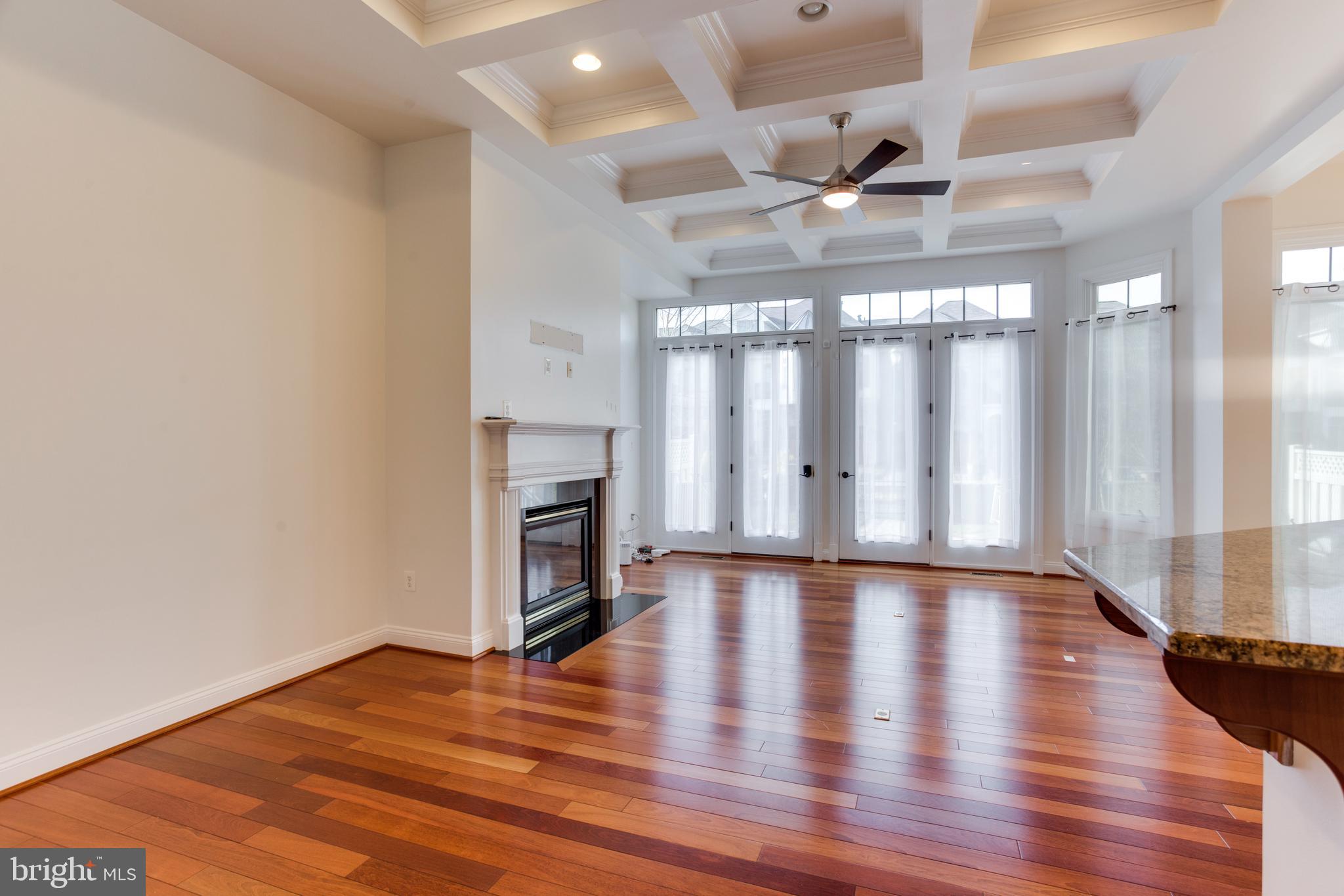 18353 Fairway Oaks Square Leesburg, VA 20176 - Photo 12 of 50 a view of an empty room with a fireplace and wooden floor