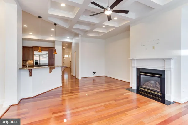 a big room with wooden floor a fireplace