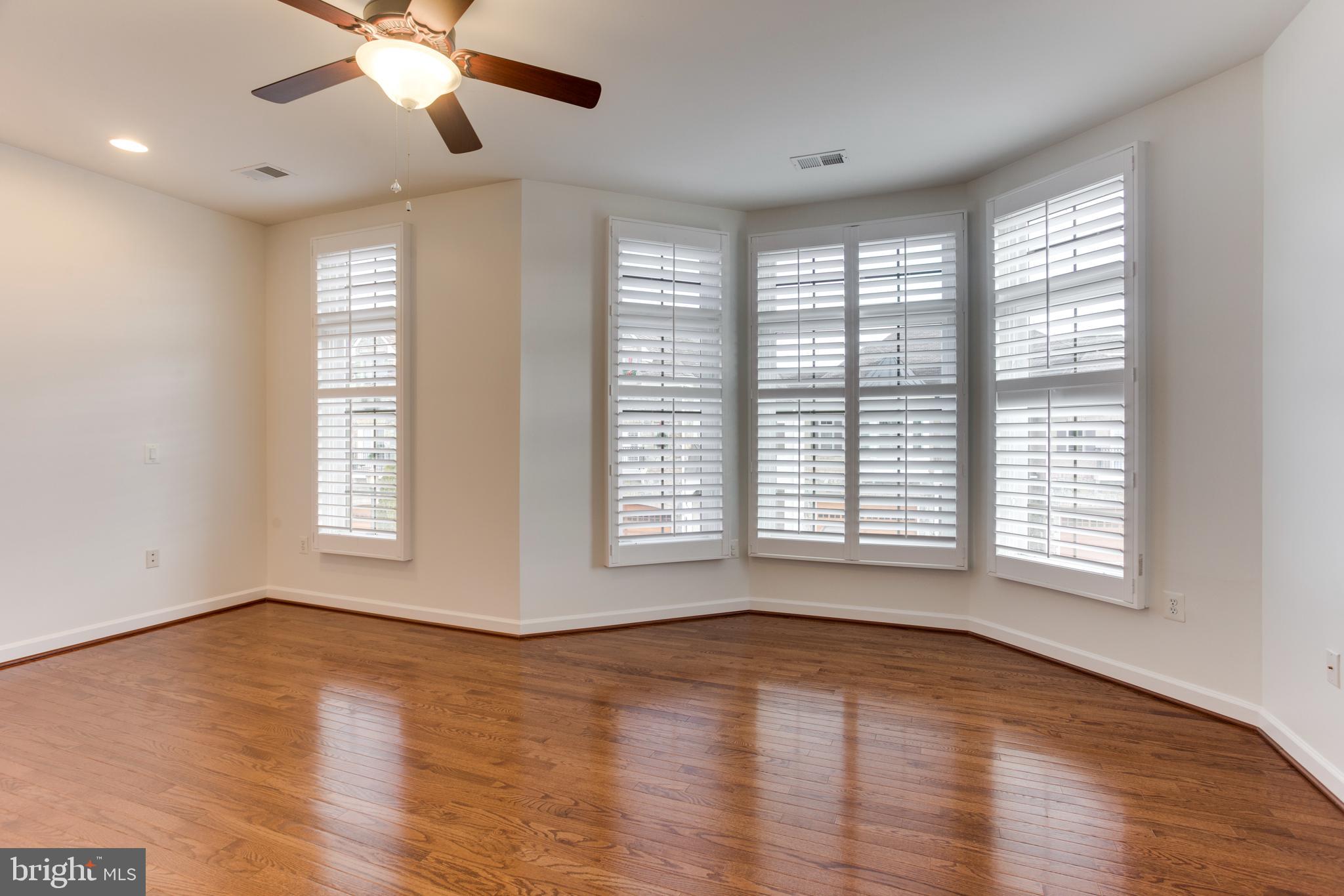 18353 Fairway Oaks Square Leesburg, VA 20176 - Photo 28 of 50 a view of an empty room with wooden floor and a window