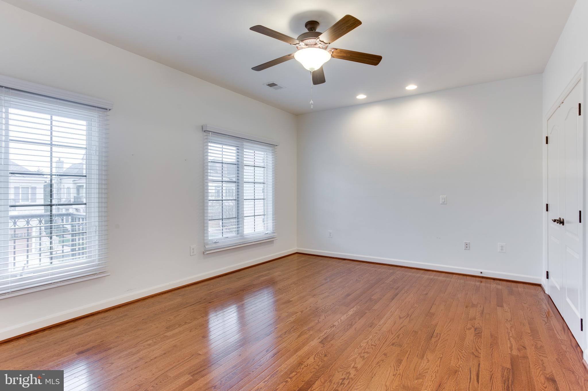 18353 Fairway Oaks Square Leesburg, VA 20176 - Photo 30 of 50 an empty room with wooden floor and windows