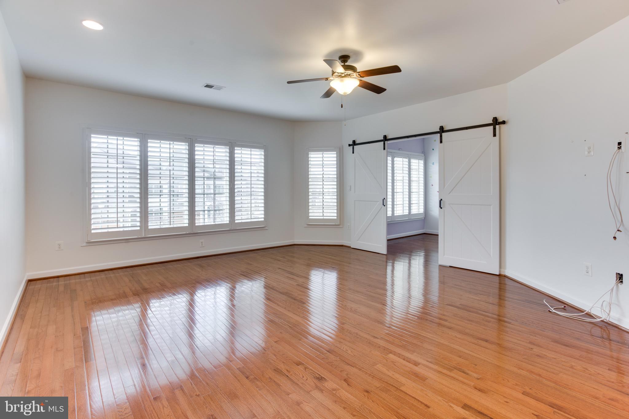 18353 Fairway Oaks Square Leesburg, VA 20176 - Photo 36 of 50 a view of an empty room with wooden floor and a window