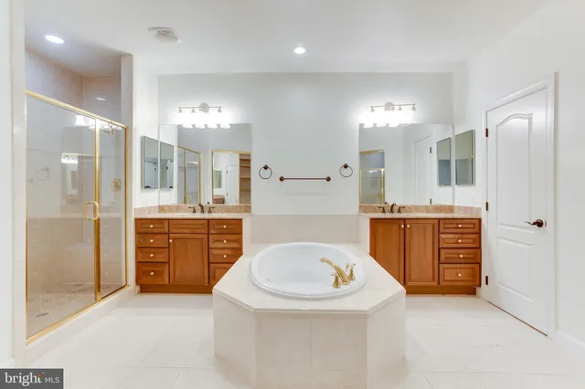 a bathroom with a sink a vanity a large mirror and a shower
