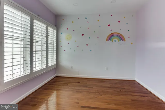 a view of room with window and wooden floor