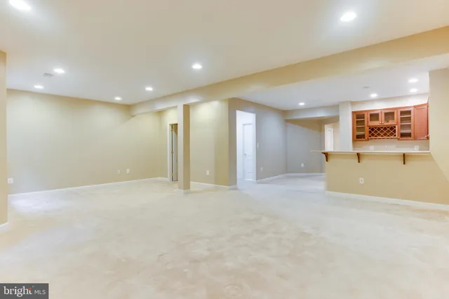 a view of an empty room with a cabinet and a window