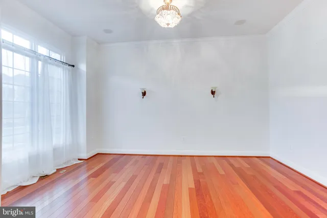 a view of a room with wooden floor and white walls