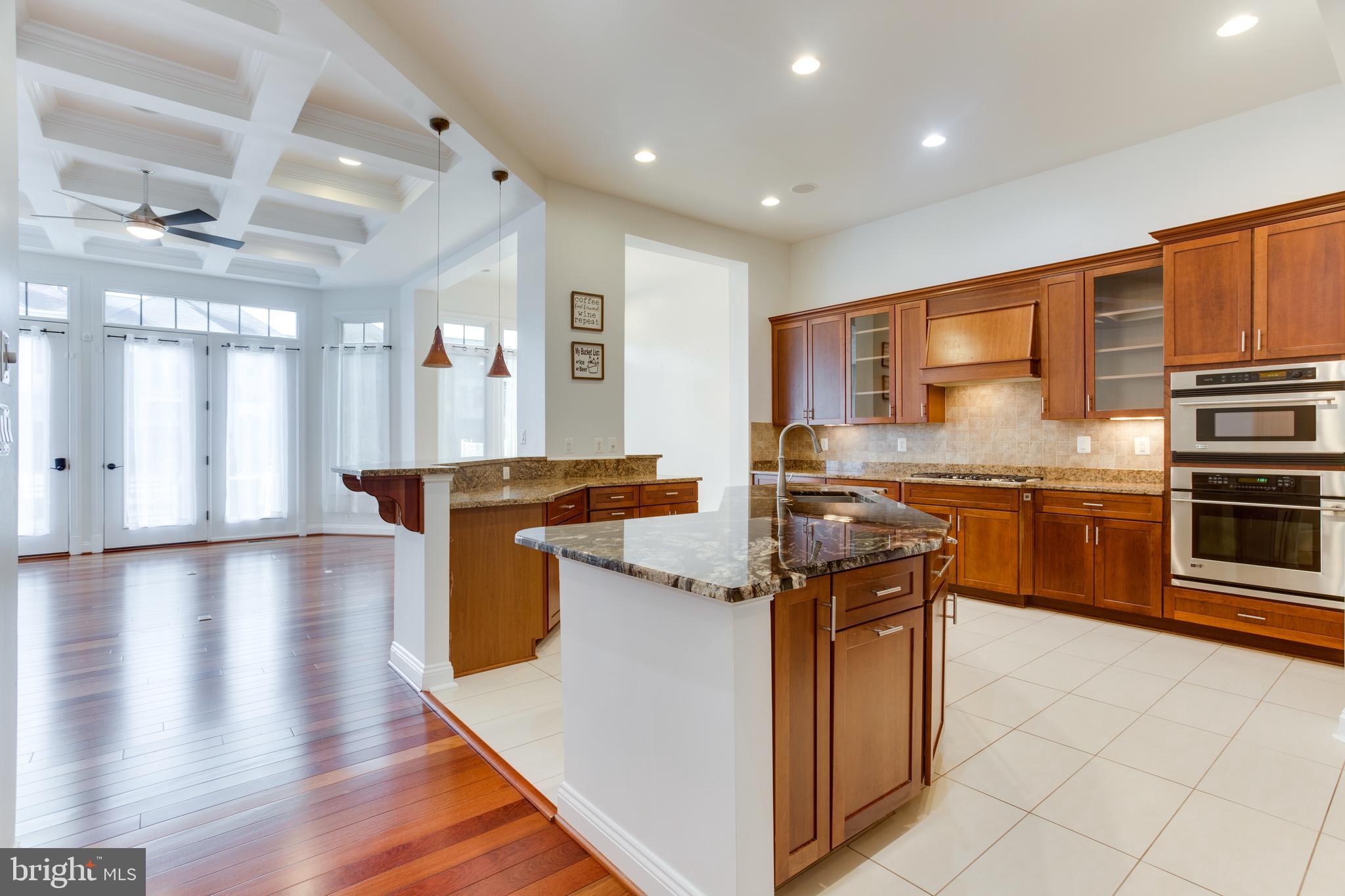 18353 Fairway Oaks Square Leesburg, VA 20176 - Photo 8 of 50 a kitchen with stainless steel appliances granite countertop a stove and a refrigerator