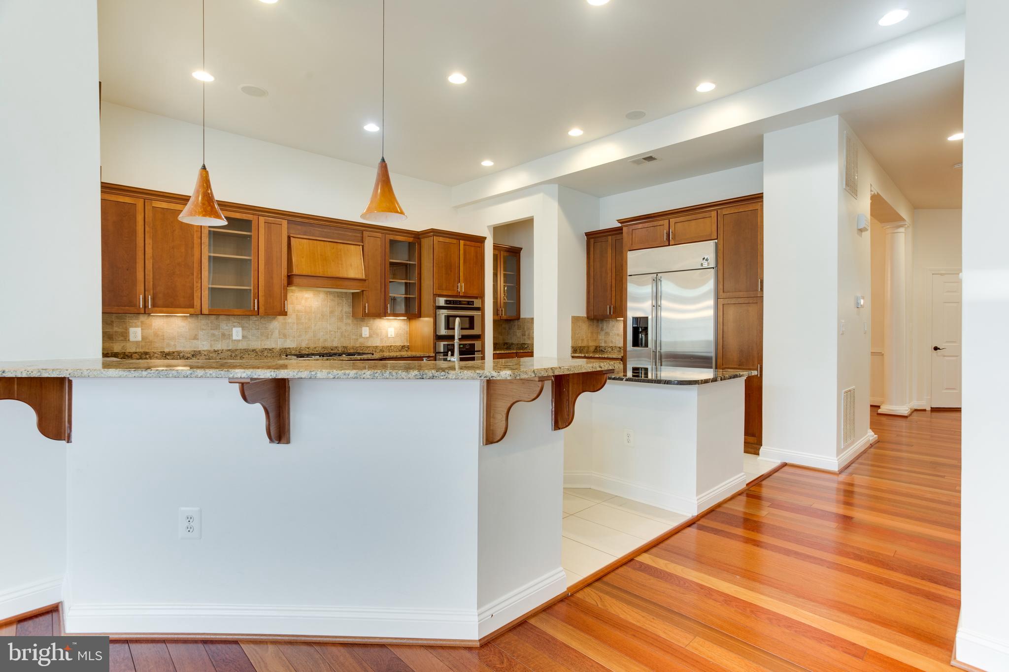 18353 Fairway Oaks Square Leesburg, VA 20176 - Photo 10 of 50 a kitchen with stainless steel appliances granite countertop a refrigerator a stove and a sink