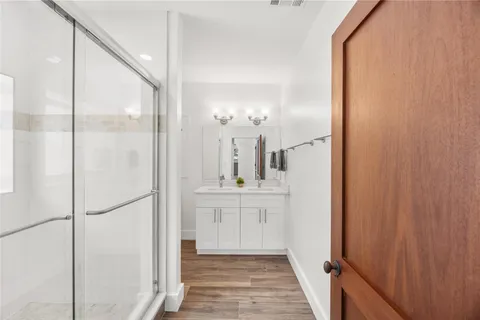 a bathroom with a double vanity sink and a mirror