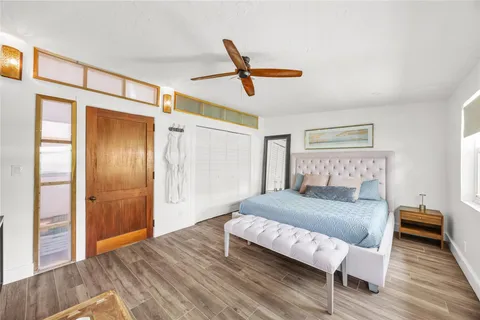 a bedroom with a bed and wooden floor