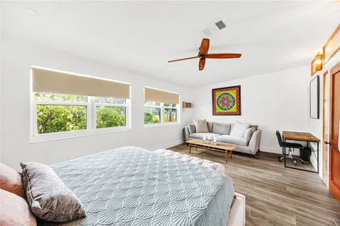 a bedroom with a bed and wooden floor