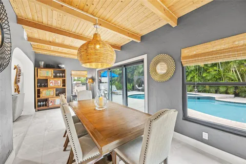 a dining room with furniture and a large window