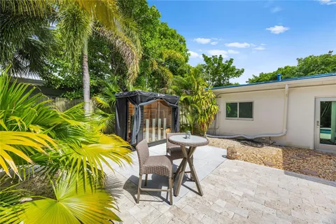 a view of a backyard with plants and patio