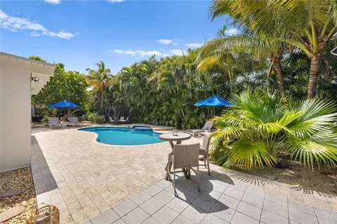 a view of a swimming pool with a table and chairs
