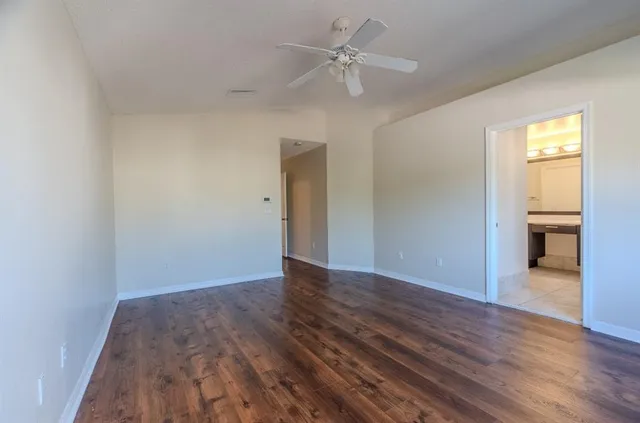 wooden floor in an empty room with a window