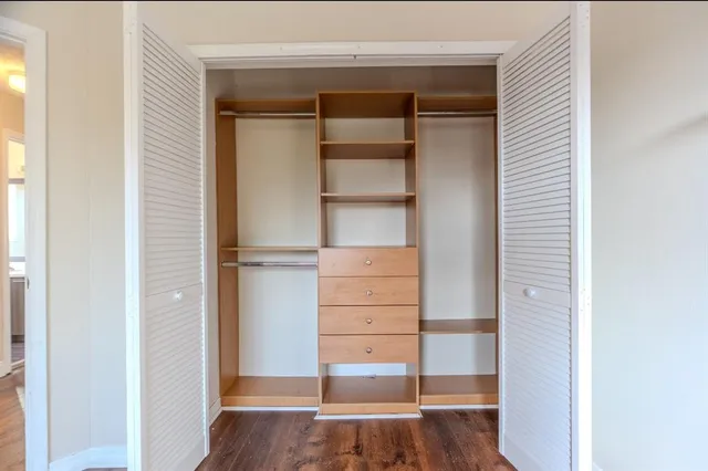 a view of walk in closet with empty racks