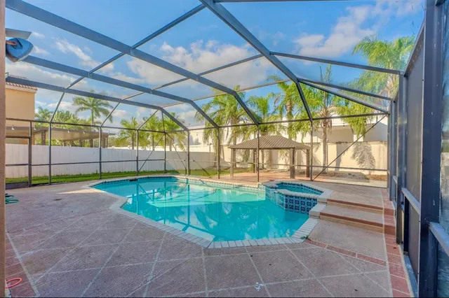 a view of a swimming pool with a table and chairs