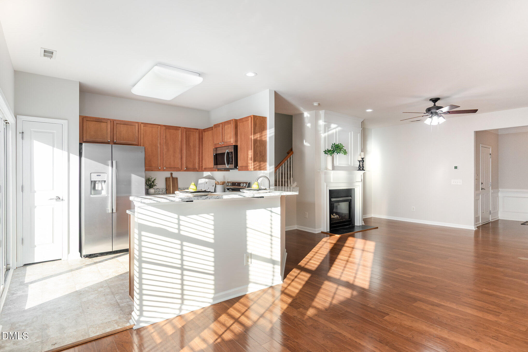 8325 Pilots View Drive Raleigh, NC 27617 - Photo 12 of 28 a kitchen with stainless steel appliances kitchen island granite countertop a refrigerator a sink a stove and white cabinets with wooden floor