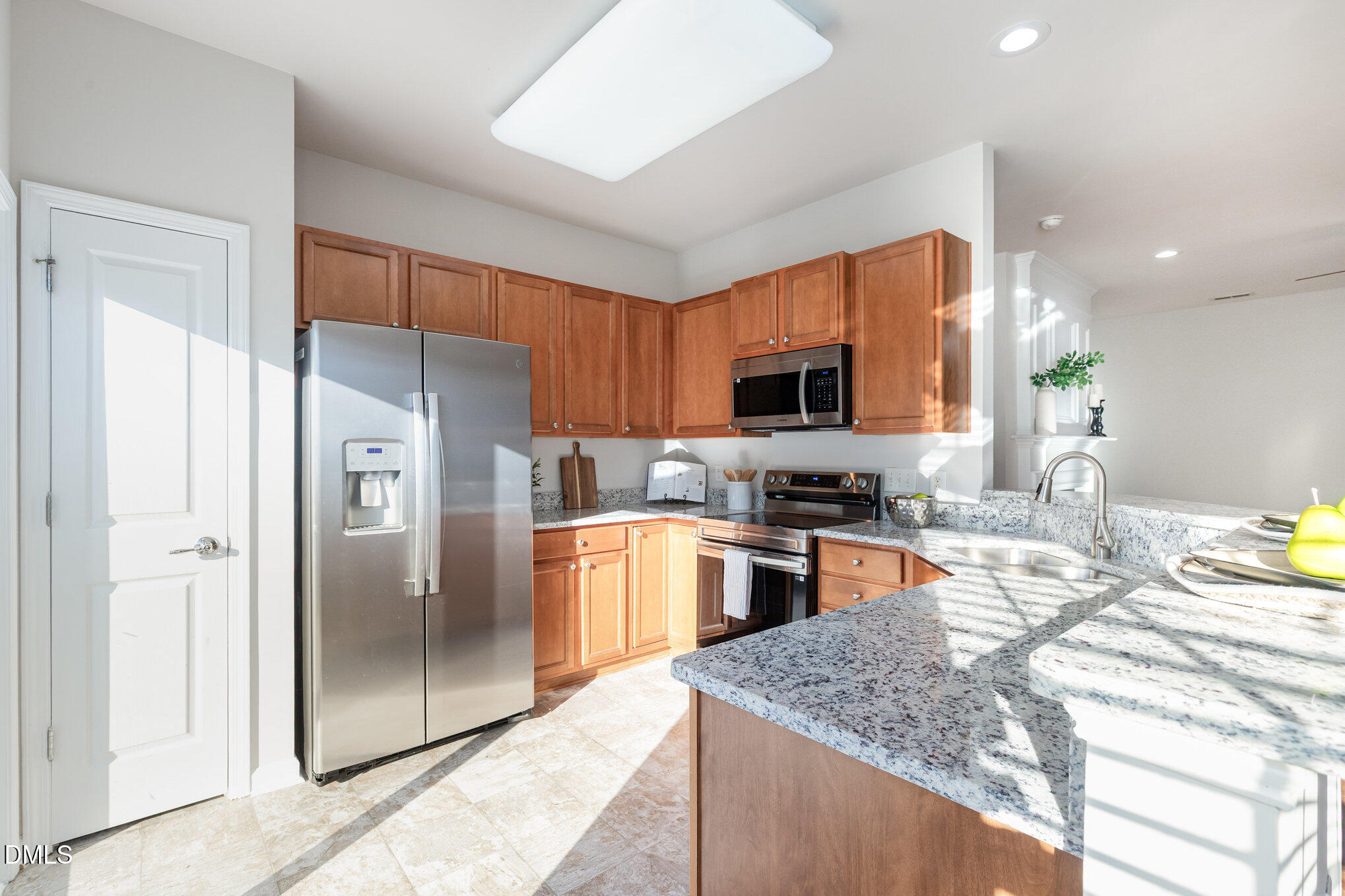 8325 Pilots View Drive Raleigh, NC 27617 - Photo 13 of 28 a kitchen with stainless steel appliances granite countertop a refrigerator stove top oven and sink