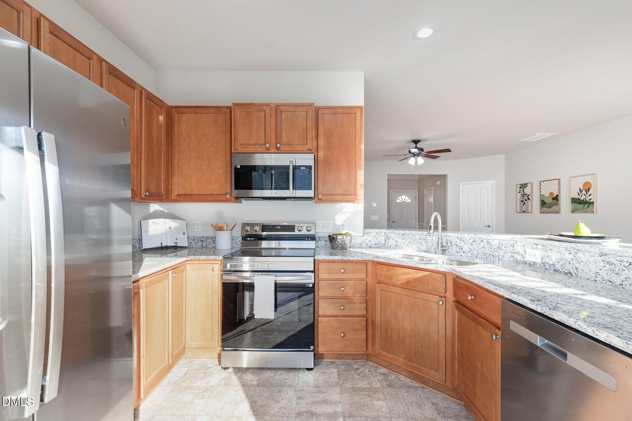 8325 Pilots View Drive Raleigh, NC 27617 - Photo 14 of 28 a kitchen with stainless steel appliances granite countertop a sink stove refrigerator and cabinets