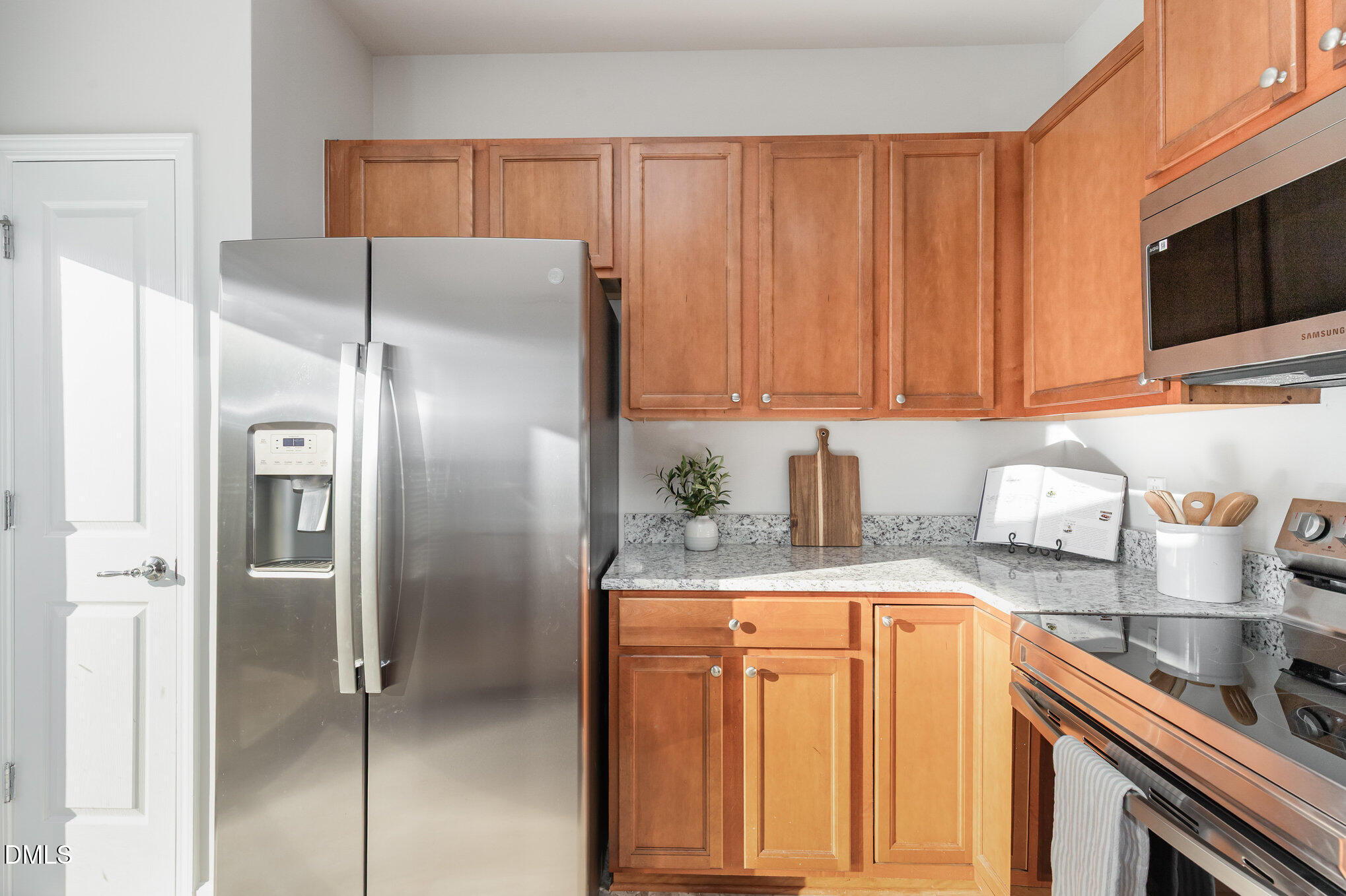 8325 Pilots View Drive Raleigh, NC 27617 - Photo 16 of 28 a kitchen with stainless steel appliances granite countertop a refrigerator and a stove top oven
