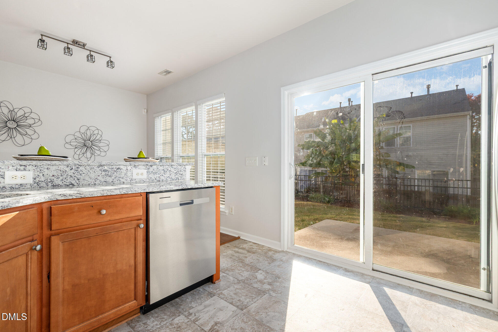 8325 Pilots View Drive Raleigh, NC 27617 - Photo 17 of 28 a kitchen with granite countertop a refrigerator a sink and a large window