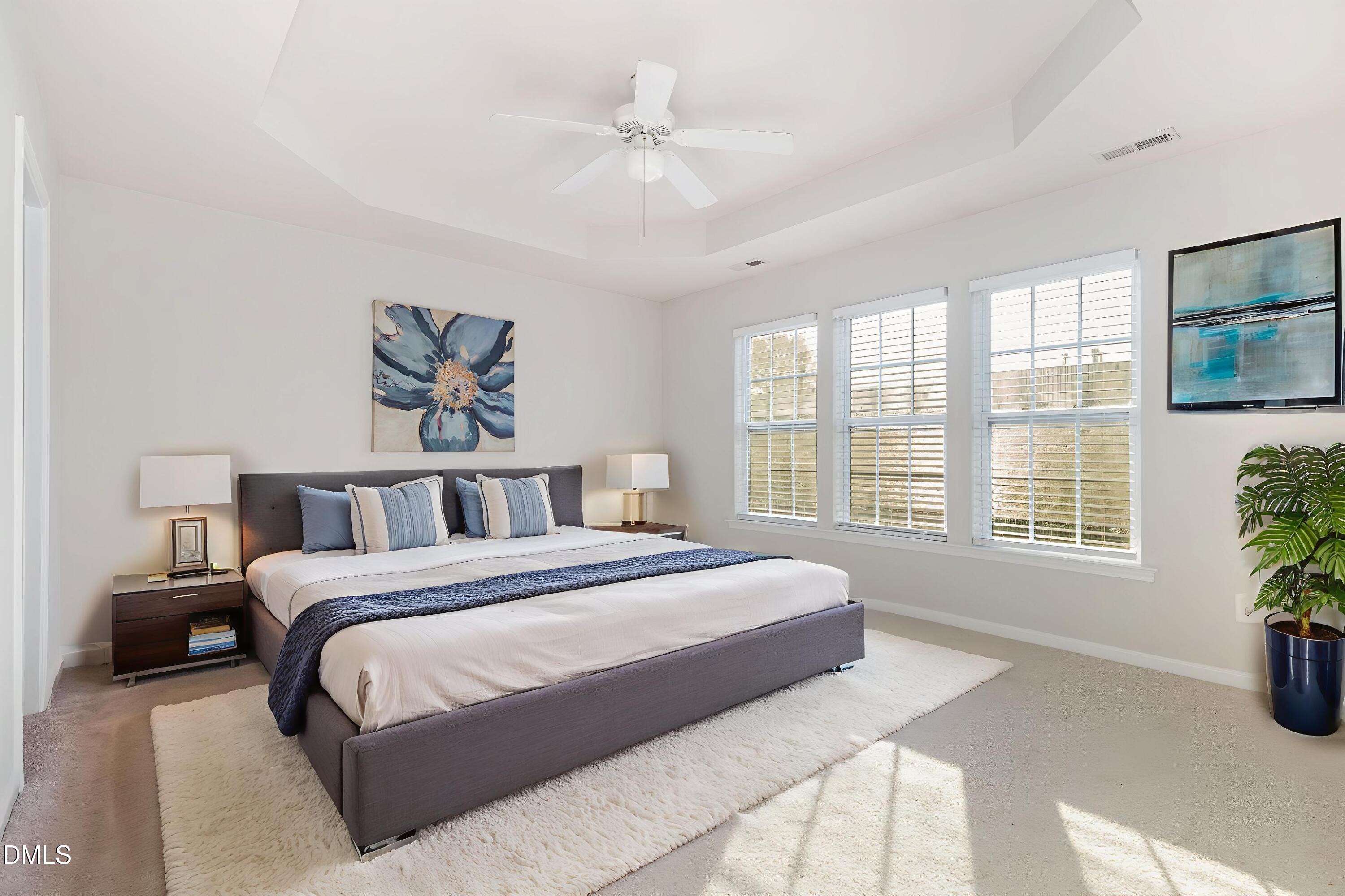8325 Pilots View Drive Raleigh, NC 27617 - Photo 19 of 28 a spacious bedroom with a large bed and a chandelier