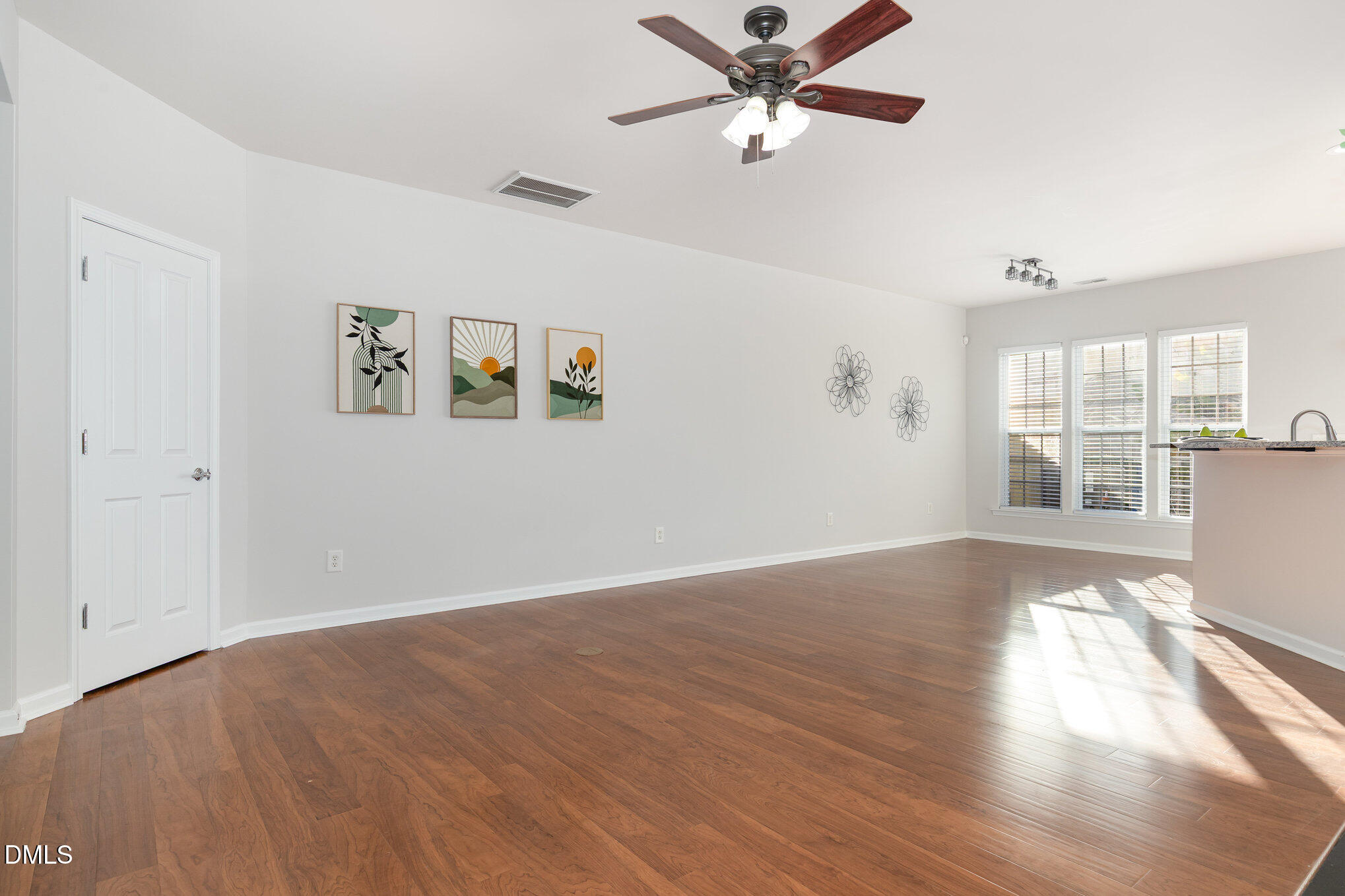 8325 Pilots View Drive Raleigh, NC 27617 - Photo 9 of 28 wooden floor in an empty room with a window