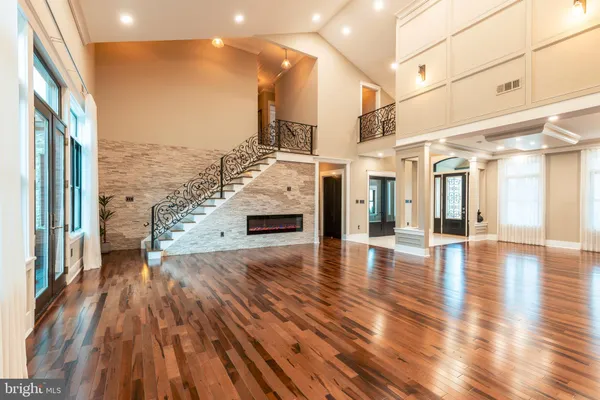 a large kitchen with stainless steel appliances kitchen island a large counter top a sink a stove and a refrigerator