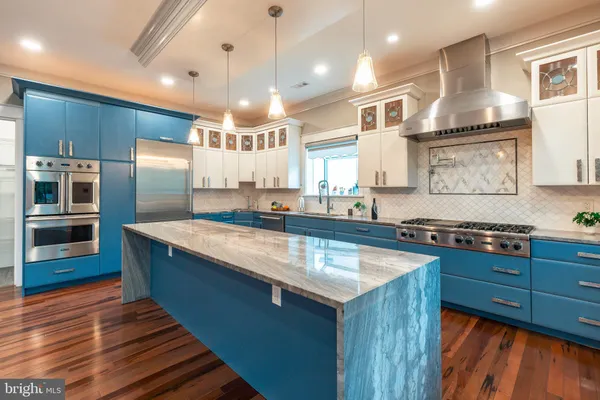 a kitchen with stainless steel appliances granite countertop a stove and a sink