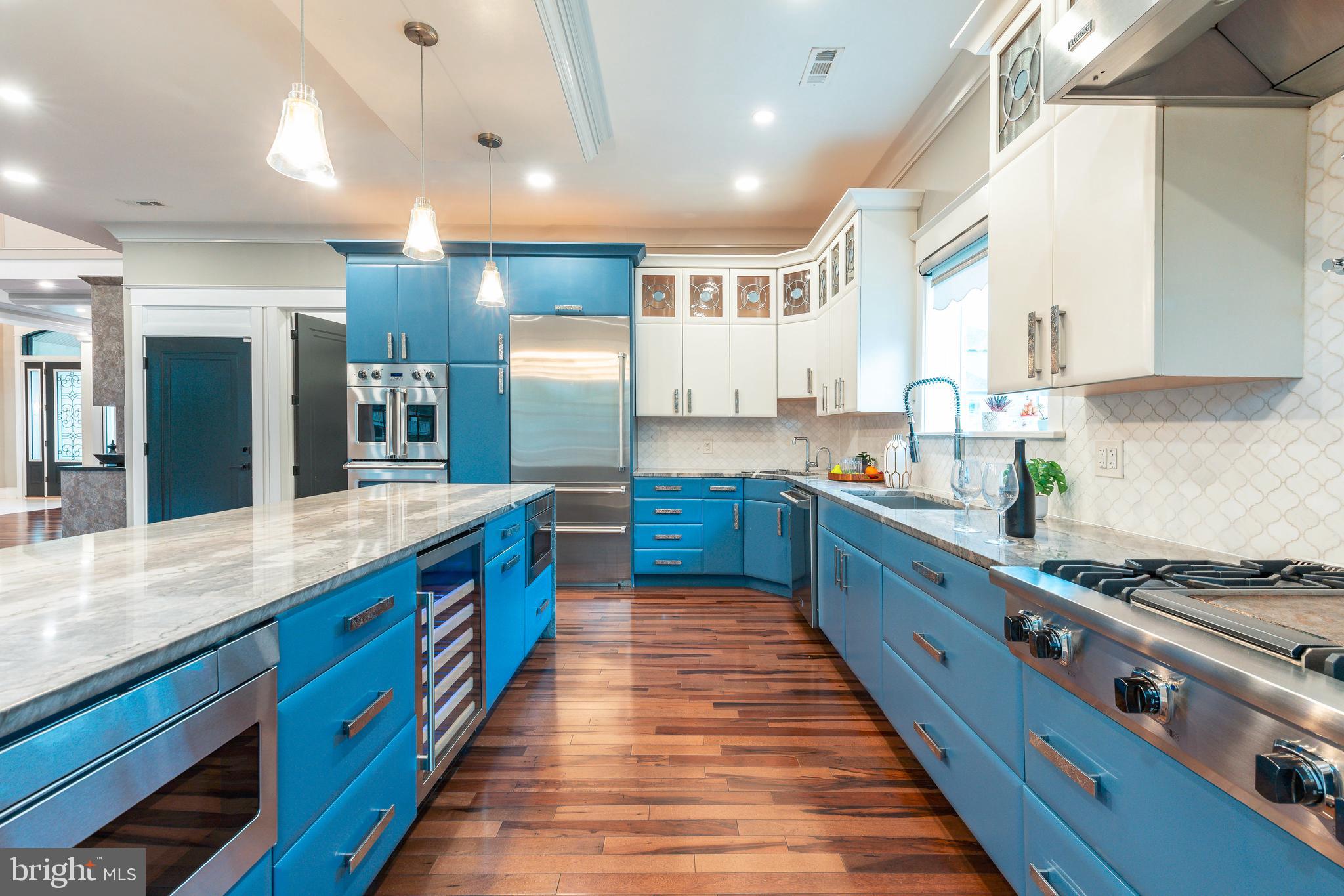 1226 Norwalk Road Philadelphia, PA 19115 - Photo 16 of 68 a large kitchen with stainless steel appliances kitchen island a large counter top a sink a stove and a refrigerator