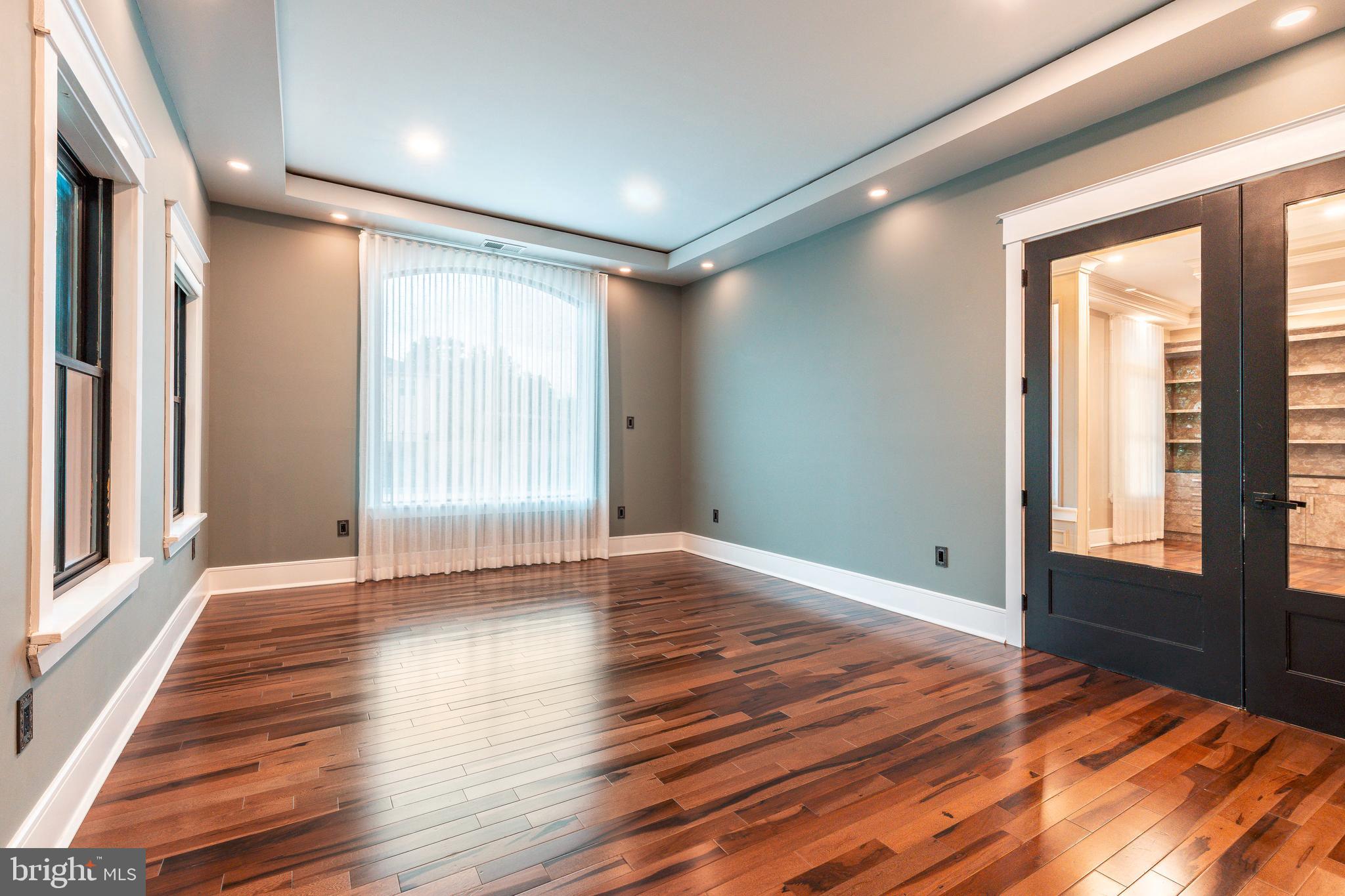 1226 Norwalk Road Philadelphia, PA 19115 - Photo 19 of 68 a view of an empty room with wooden floor and a window