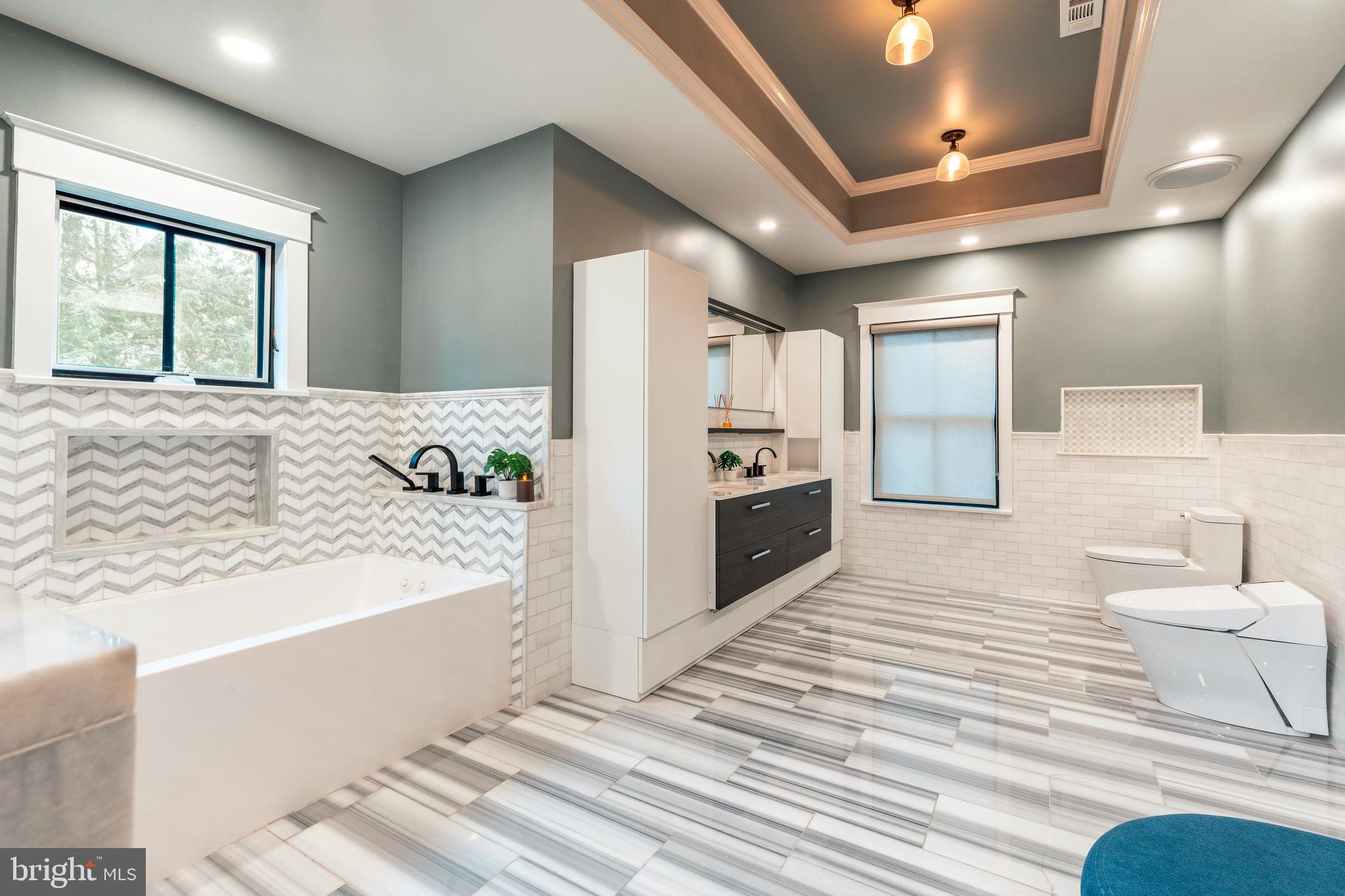 1226 Norwalk Road Philadelphia, PA 19115 - Photo 26 of 68 a spacious bathroom with a tub and mirror