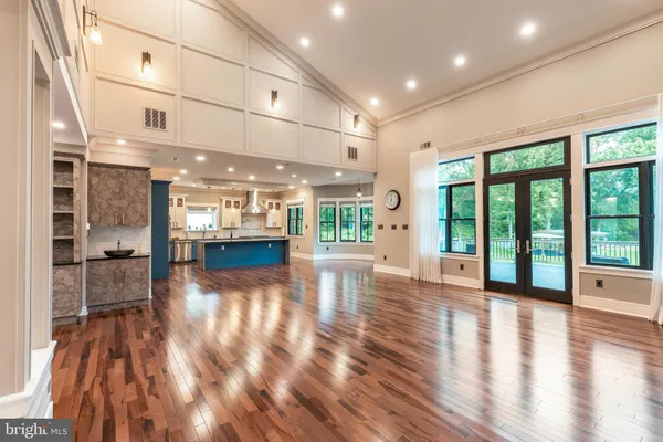 a large kitchen with stainless steel appliances kitchen island granite countertop a refrigerator and a sink