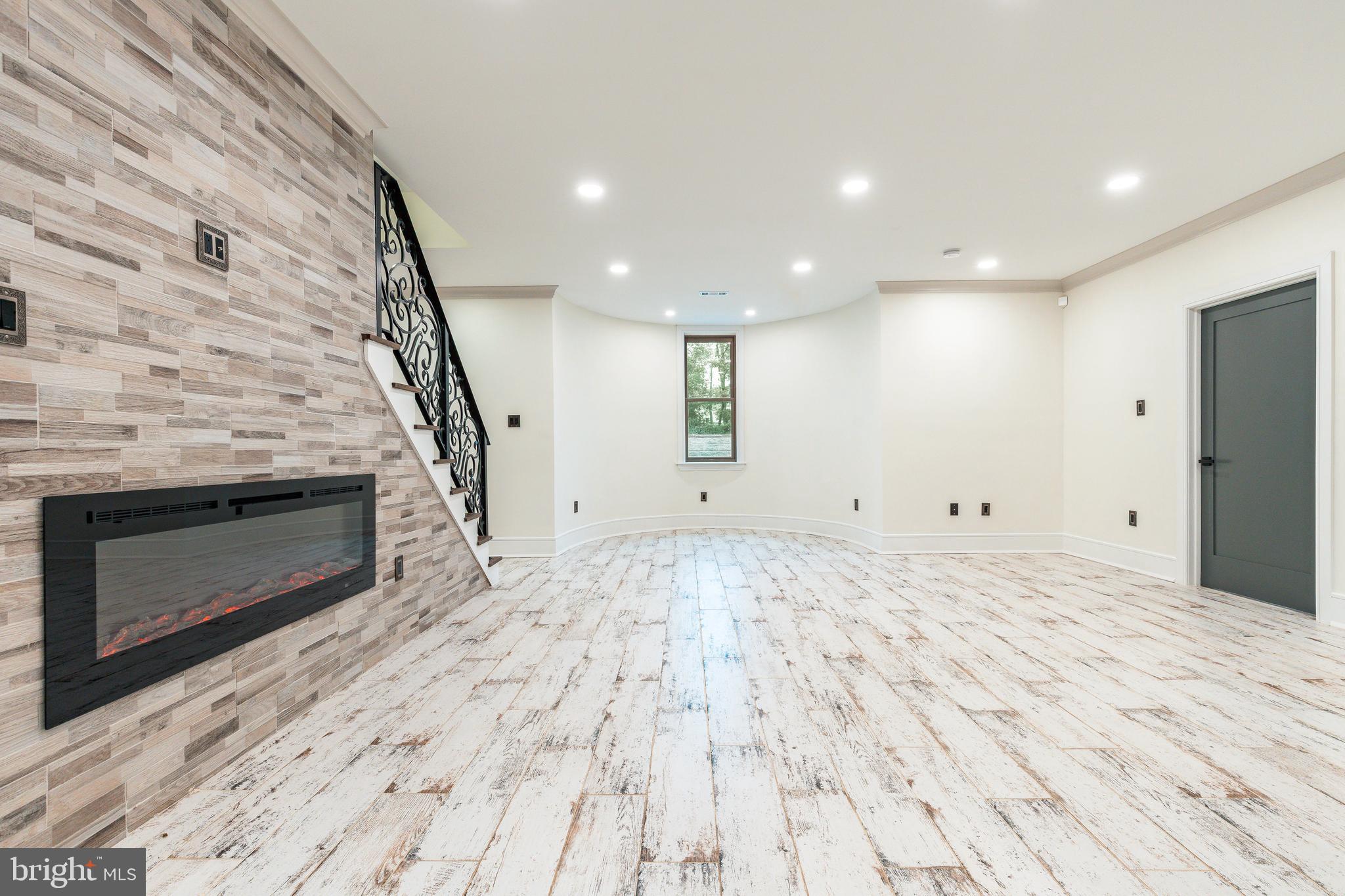 1226 Norwalk Road Philadelphia, PA 19115 - Photo 30 of 68 a view of empty room with wooden floor and fireplace