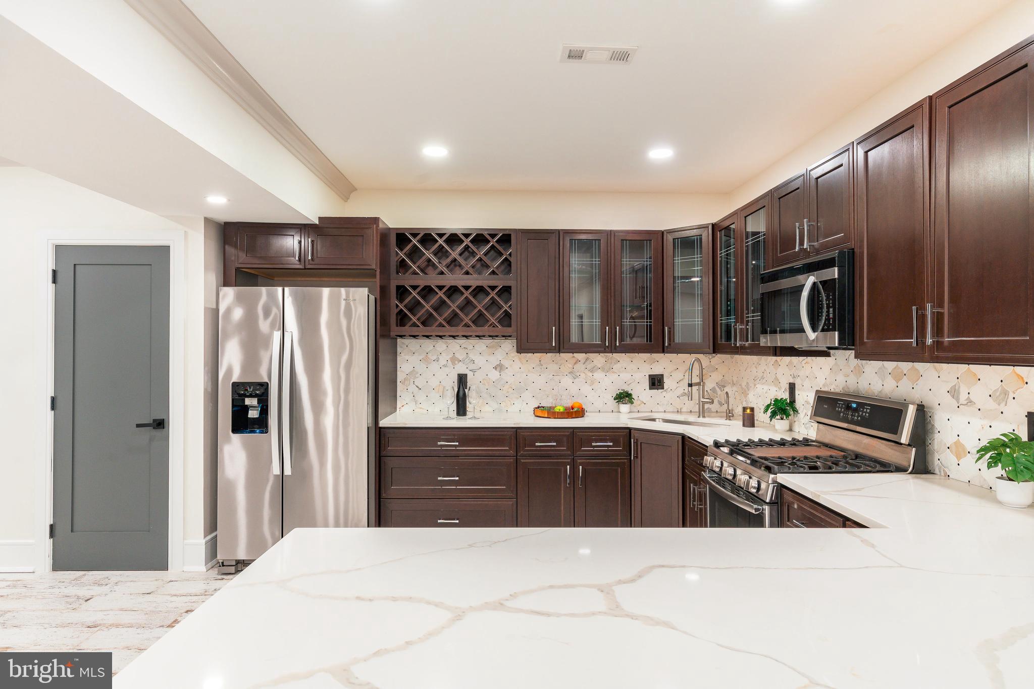 1226 Norwalk Road Philadelphia, PA 19115 - Photo 34 of 68 a large kitchen with stainless steel appliances kitchen island granite countertop a refrigerator and a sink