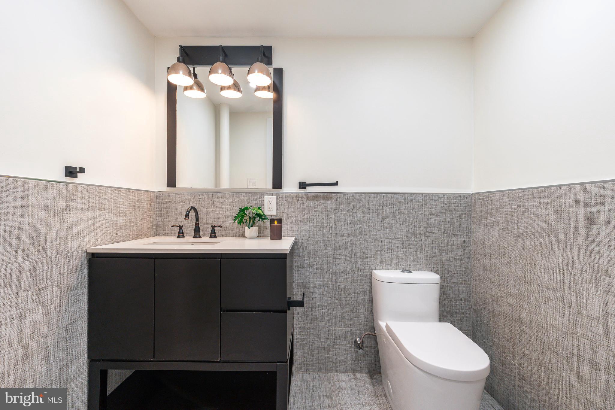 1226 Norwalk Road Philadelphia, PA 19115 - Photo 35 of 68 a bathroom with a toilet sink and mirror