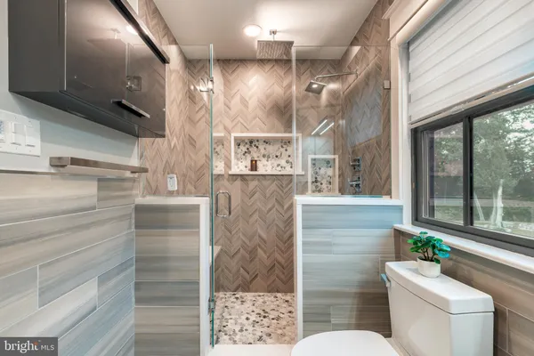 a view of swimming pool with seating area and trees around