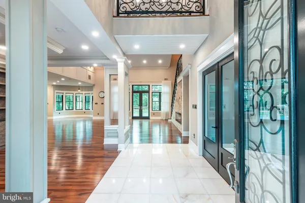 a hallway with wooden floor and windows